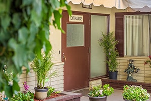 The front Entrance door with awning of the Sunrise Post Acute facility